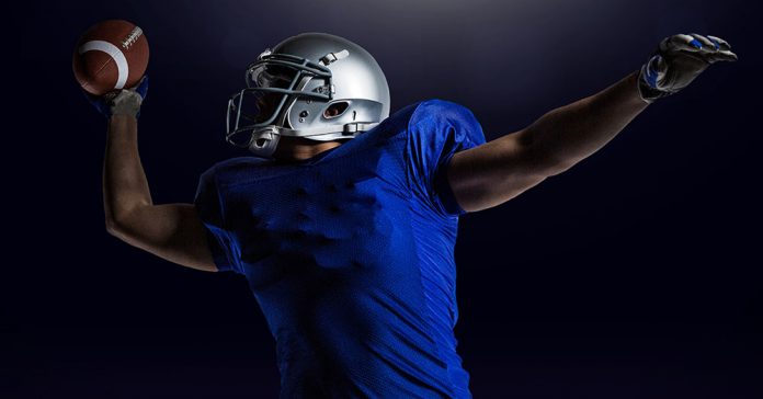 American football player catching ball